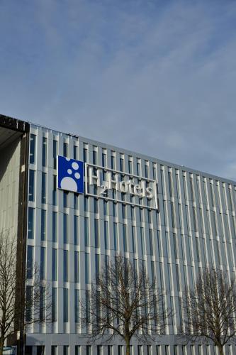 a building with a sign on the side of it at H2 Hotel München Messe in Munich