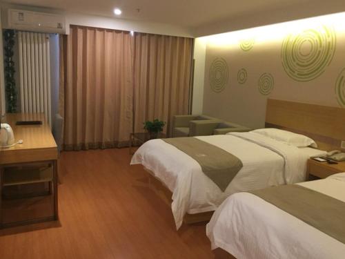 a hotel room with two beds and a desk at GreenTree Inn Beijing Tongzhou District Yujiawu Technology park Express Hotel in Tongzhou