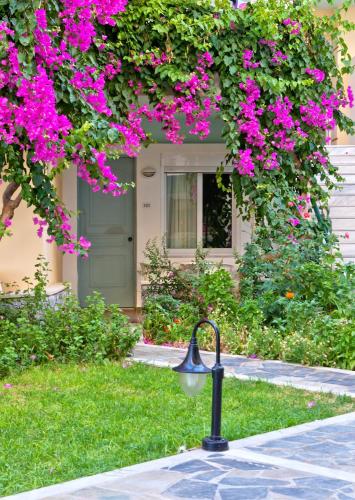 a street light in front of a house with pink flowers at Dedalos Beach Hotel in Sfakaki