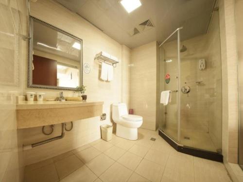 a bathroom with a toilet and a sink and a shower at GreenTree Inn Anhui Hefei Tianehu Wanda Square Express Hotel in Hefei