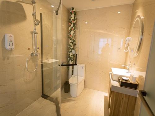 Ett badrum på Shell Zhengzhou Zhongyuan Fota Hotel