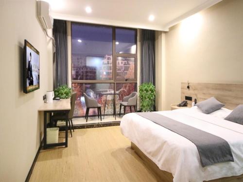 Ένα ή περισσότερα κρεβάτια σε δωμάτιο στο GreenTree Inn ShanDong ZaoZhuang TengZhou FuQian Road LongQuan Square Business Hotel