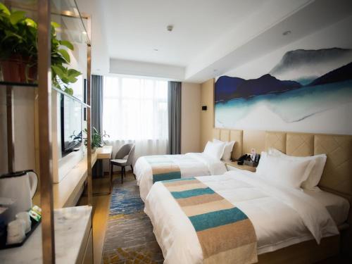 Katil atau katil-katil dalam bilik di VX Heze Dingtao District Taoyi Road Hotel