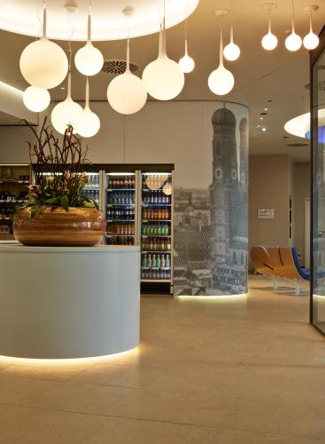 a lobby of a store with pendant lights at H2 Hotel München Messe in Munich