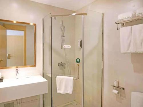 a bathroom with a shower and a sink at GreenTree Inn Jiangxi Yingtan Xinjiang Area Government No. 1 Middle Business Hotel in Yingtan