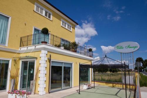a yellow building with a sign on the side of it at Villa Imago in Roseto degli Abruzzi