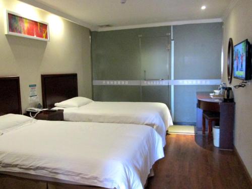 Ένα ή περισσότερα κρεβάτια σε δωμάτιο στο GreenTree Inn Anhui Suzhou Dangshan Dayukou Express Hotel