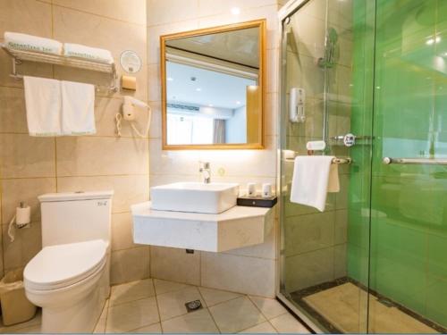 a bathroom with a toilet and a sink and a shower at GreenTree Inn Maanshan East Railway Station Oushang Supermarket Business Hotel in Fengqiao