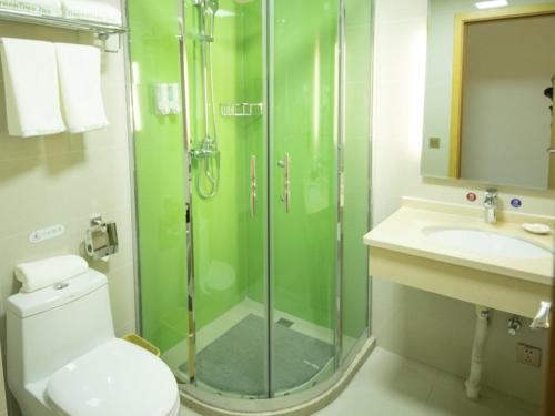 a bathroom with a shower and a toilet and a sink at GreenTree Inn Handan City Wu'an City Plaza Business Hotel in Handan