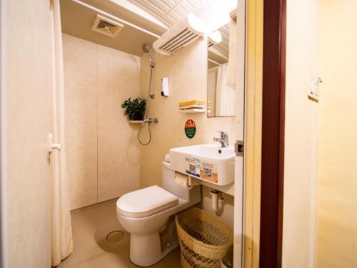 a small bathroom with a toilet and a sink at GreenTree Inn Tianjin Huayuankeyuan Business Hotel in Tianjin