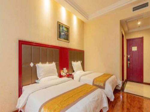 a hotel room with two beds in a room at GreenTree Inn Zhangjiakou Yu County Bus Station Business Hotel in Xiaowa