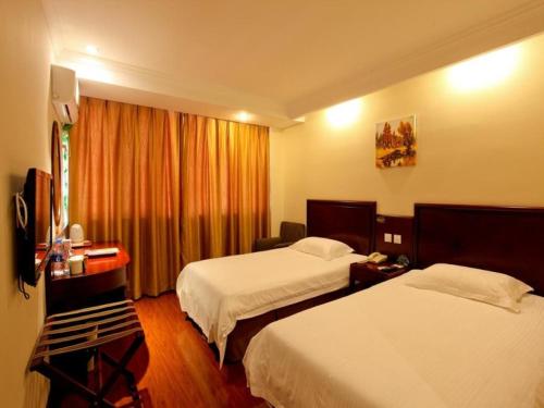 a hotel room with two beds and a window at GreenTree Inn Anhui Hefei Economic Development Zone Convention and Exhibition Center Business Hotel in Hefei