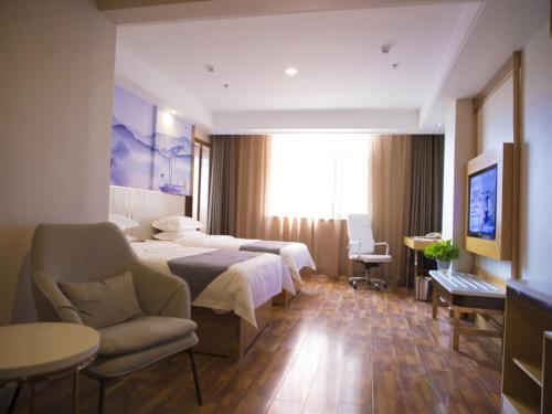 a hotel room with two beds and a tv at GreenTree Eastern Taiyuan Jinyuan District Xinjinyu Road Hotel in Taiyuan