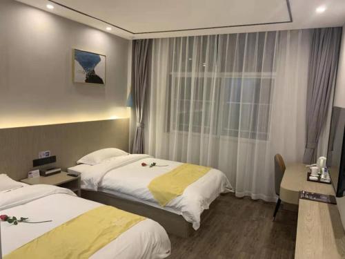 Voodi või voodid majutusasutuse Shell Xuzhou Tongshan District Maocun Town Renmin Road Hotel toas