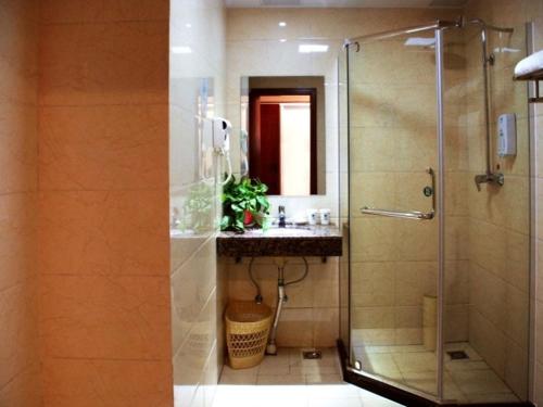a bathroom with a shower and a sink at GreenTree Inn ShanDong WeiFang LinQu ZhanQian Road LuChuan Business Hotel in Linqu
