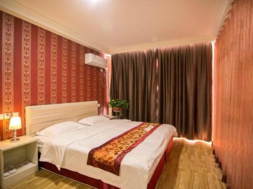 Katil atau katil-katil dalam bilik di Shell Shandong Weifang Linqu Donghuan road Hotel