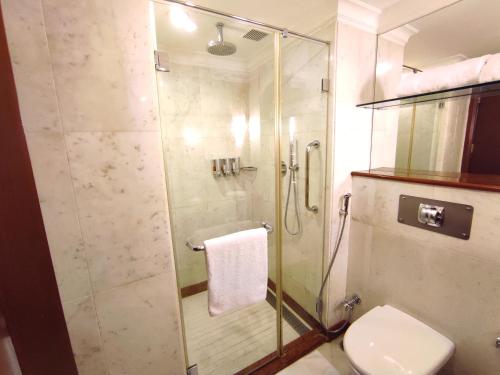 a bathroom with a shower and a toilet at Welcomhotel by ITC Hotels, Alkapuri, Vadodara in Vadodara