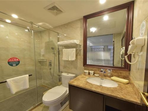 a bathroom with a toilet and a sink and a shower at GreenTree Inn JiangSu Changzhou Dinosaur Park Global Harbor Express Hotel in Changzhou