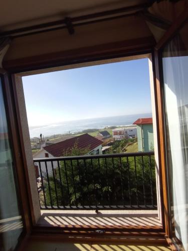 a window view of the ocean from a condo at Hotel A Raiña in Oia