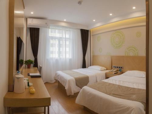 Una cama o camas en una habitación de GreenTree Inn Bengbu Longzihu District Railway Station Express Hotel