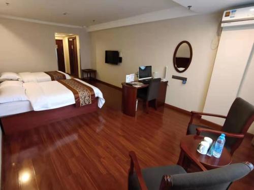 a hotel room with a large bed and a desk at GreenTree Inn Shanghai Jiading Dazhong International Auto City Business Hotel in Jiading