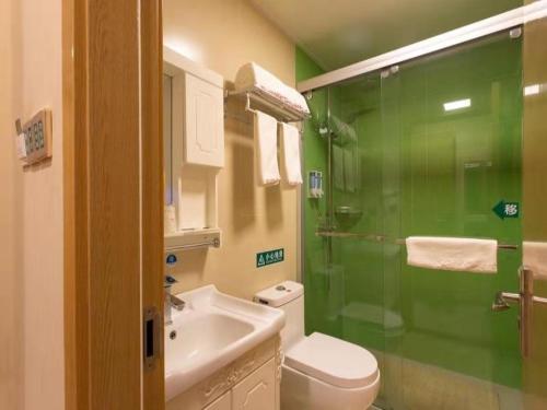 a bathroom with a shower and a toilet and a sink at Shell Zhenjiang Xijindu Jinshan Park Hotel in Zhenjiang