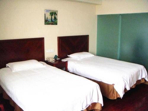 two beds in a hotel room with white sheets at GreenTree Inn Jiangsu Zhenjiang Yidu Building Materials city Express Hotel in Zhenjiang