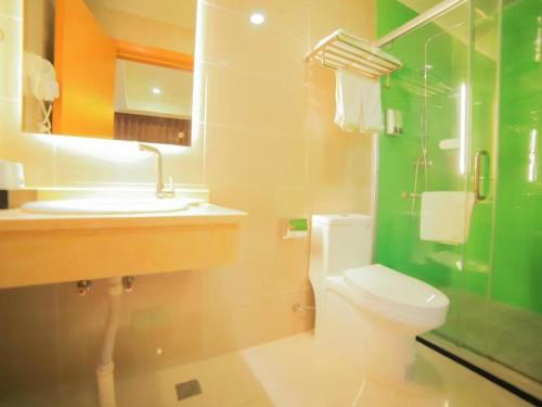 a bathroom with a toilet and a sink and a mirror at GreenTree Inn Beijing Huairou District Beifang Town Xingfu Avenue Business Hotel in Huairou