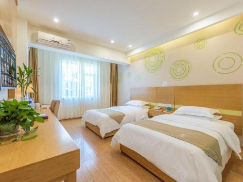 a hotel room with two beds in a room at GreenTree Inn Anhui Anqing Susong North longmen road express Hotel in Yinwan