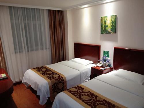 a hotel room with two beds and a window at GreenTree Inn Beijing Fangshan Liangxiang Suzhuang Express Hotel in Fangshan