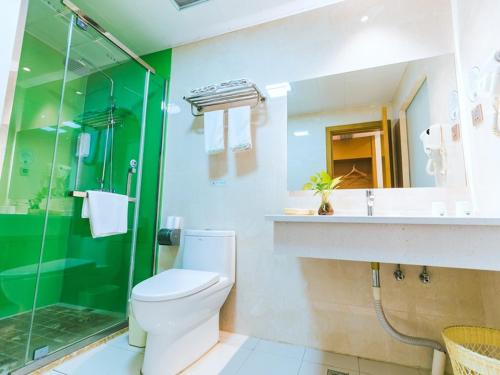a bathroom with a toilet and a shower and a sink at GreenTree Inn Huzhou Zhili Fortune Plaza Wuxing Avenue Express Hotel in Huzhou