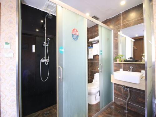 a bathroom with a shower and a sink at GreenTree Inn WenZhou LuCheng XiaoNanMen Express Hotel in Wenzhou