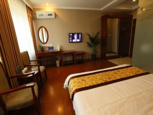 a hotel room with a large bed and a table at GreenTree Inn Beijing Changping Shahe Metro Station Express Hotel in Changping