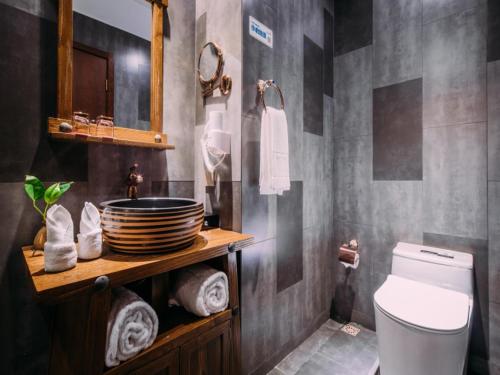a bathroom with a sink and a toilet in it at GreenTree Eastern Changzhou Liyang CityTianmu Lake Four Seasons Hotel in Liyang