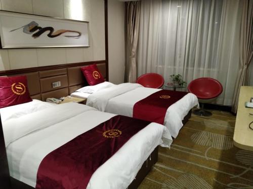 Katil atau katil-katil dalam bilik di GreenTree Alliance Xinyang Pingqiao District Nanjing Road Dongyang Hotel