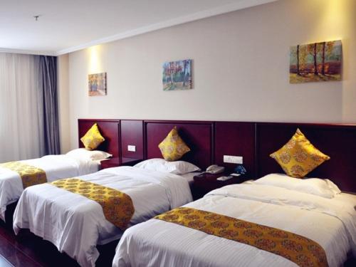 a hotel room with three beds and a telephone at GreenTree Inn XuZhou Benteng Avenue Express Hotel in Xuzhou