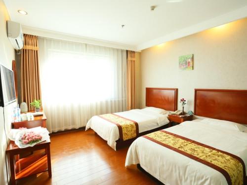 a hotel room with two beds and a window at GreenTree Inn Beijing Changping Shahe Metro Station Express Hotel in Changping