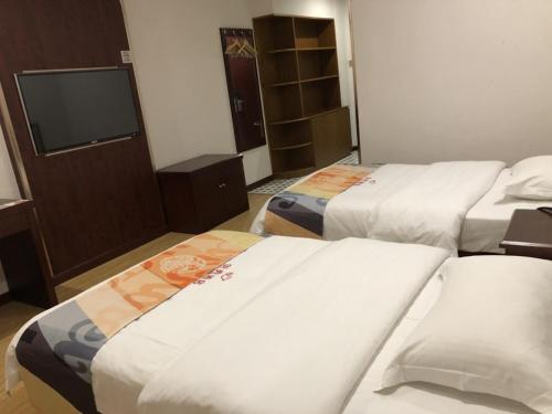 Postel nebo postele na pokoji v ubytování Shell Shanghai Jinshan Zhanyan Songjin Highway Hotel