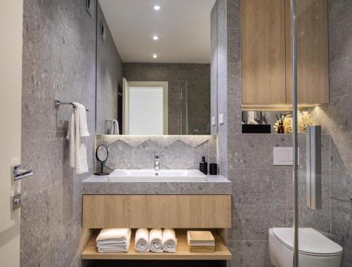 a bathroom with a sink and a toilet at Villa VinSun in Vinišće