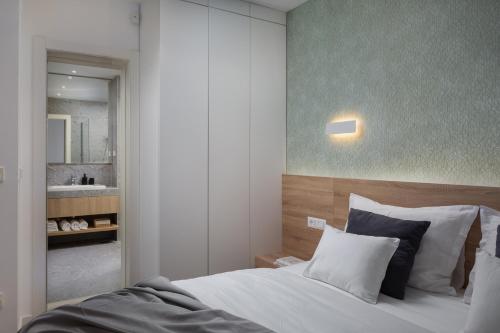 a bedroom with a large bed and a bathroom at Villa VinSun in Vinišće