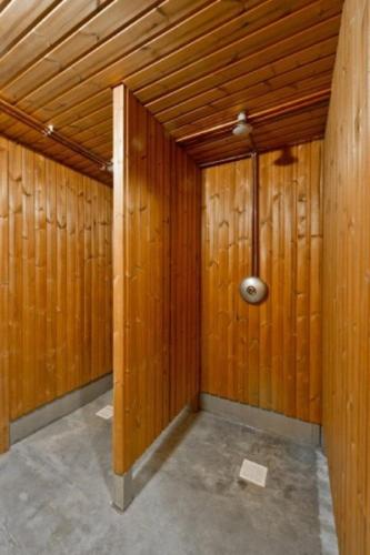 a room with wood paneled walls and a spotlight at Saulės Slėnis in Plateliai