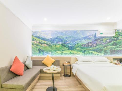 a bedroom with a large painting on the wall at GreenTree Inn ShangHai SongJiang SongDong Business Hotel in Songjiang