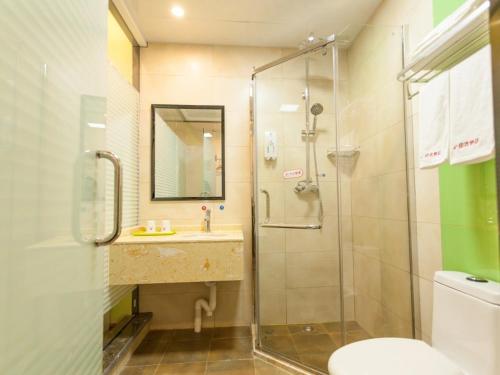 a bathroom with a shower and a sink and a toilet at Shell Hefei Economic Development Zone Hong Kong and Macao Square Hotel in Hefei