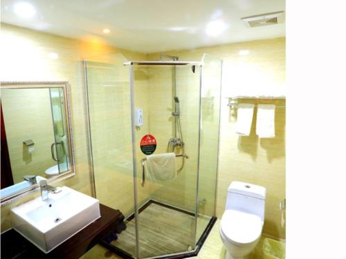 a bathroom with a shower and a toilet and a sink at GreenTree Inn JiangXi JiuJiang Railway Station Front HongXiang Business Hotel in Jiujiang