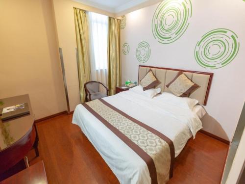 a bedroom with a large bed in a room at GreenTree Inn Jiangsu ZhenJiang Jurong New Bus Station Express Hotel in Jurong