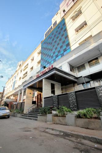 a hotel building with a car parked in front of it at Taj Tristar in Hyderabad