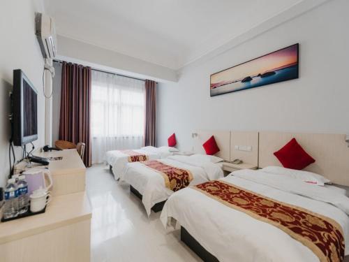 Ένα ή περισσότερα κρεβάτια σε δωμάτιο στο Shell Luoyang Lijingmen Mingtang Hotel