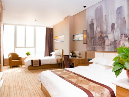 Un pat sau paturi într-o cameră la GreenTree Eastern Tianjin Wuqing Stadium Hotel