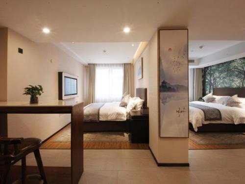 Tempat tidur dalam kamar di GME Hefei Sanxiaokou Chenghuang Temple Xinghua Park Hotel