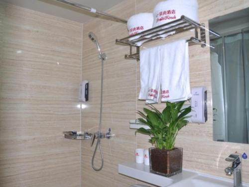 a bathroom with a shower and a sink at Shell Suzhou Yongqiao District Dongchang Road National Purchase Square Hotel in Suzhou